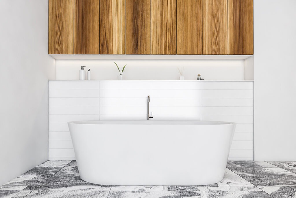 White and wooden bathroom with white bathtub on tiled marble floor, deck with gels and plant. Minimalist luxury bathroom with shelf, 3D rendering no people