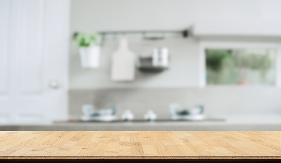 Wood table top on blurred kitchen background,