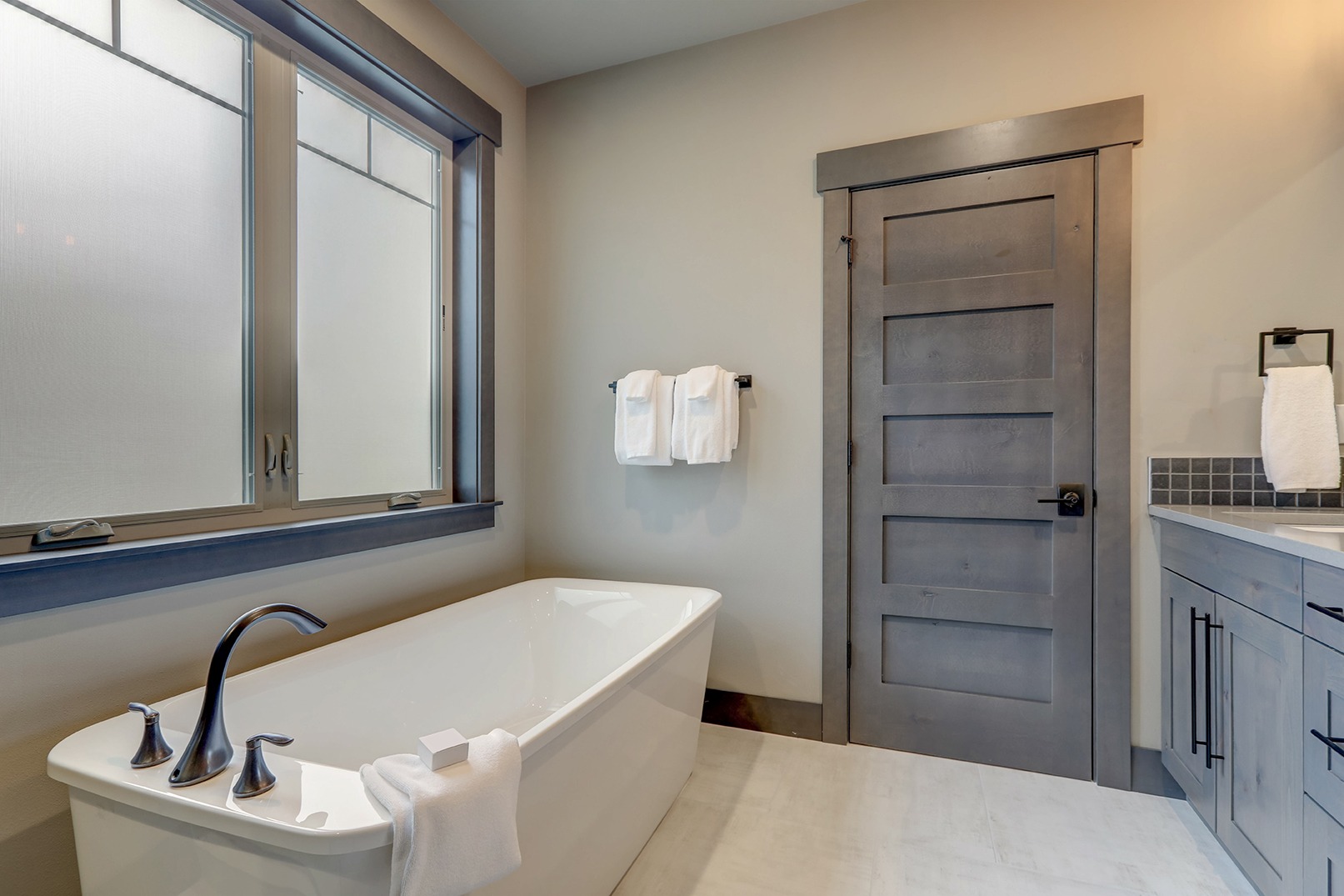 Natural new classic slick bathroom interior with modern and rustic natural design with white tub.