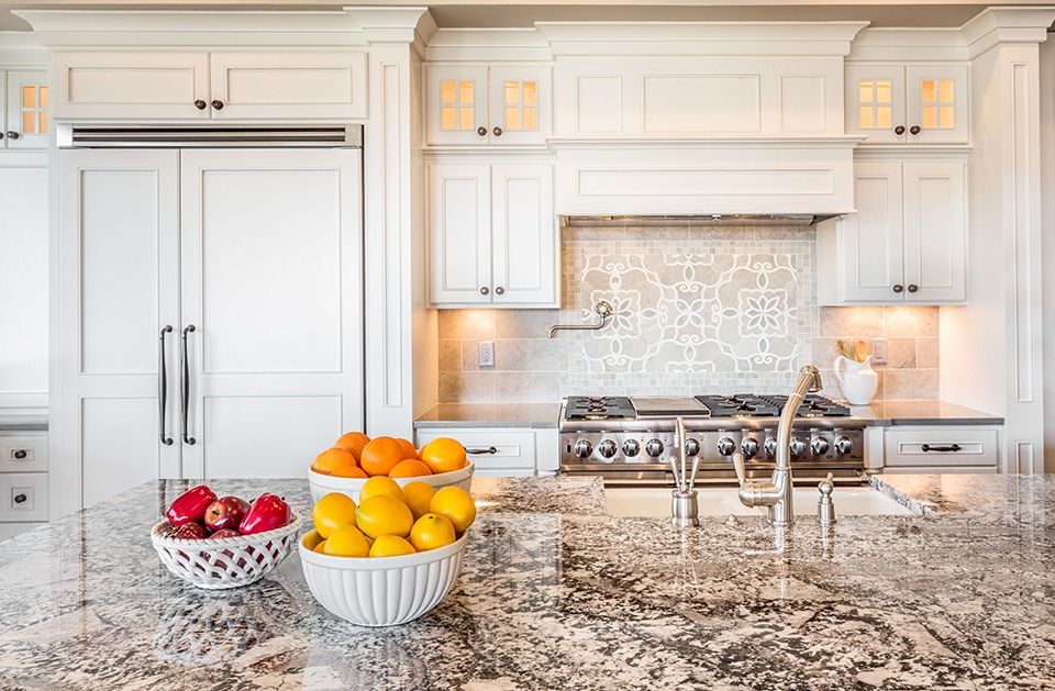Kitchen Interior Detail in New Luxury Home with Island, Sink, Cabinets, and Bowls of Fruit