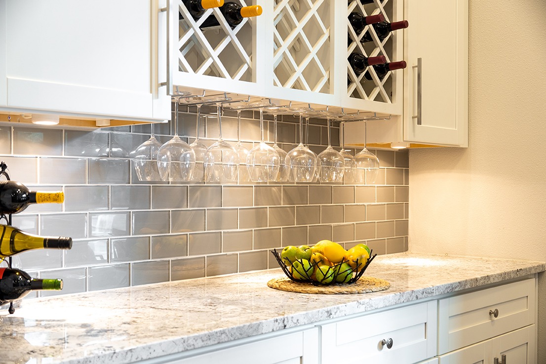 A luxury white kitchen with wood floors