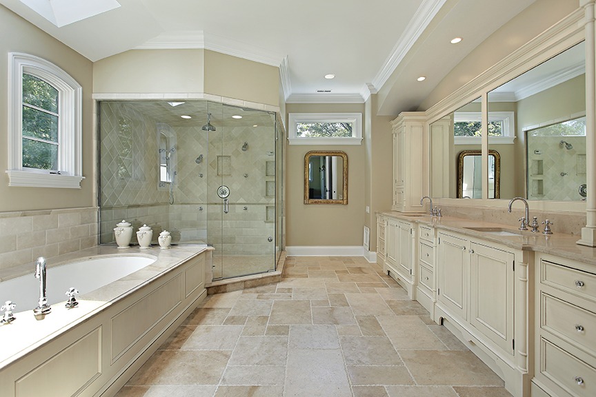 Master bath in luxury home with large glass shower
